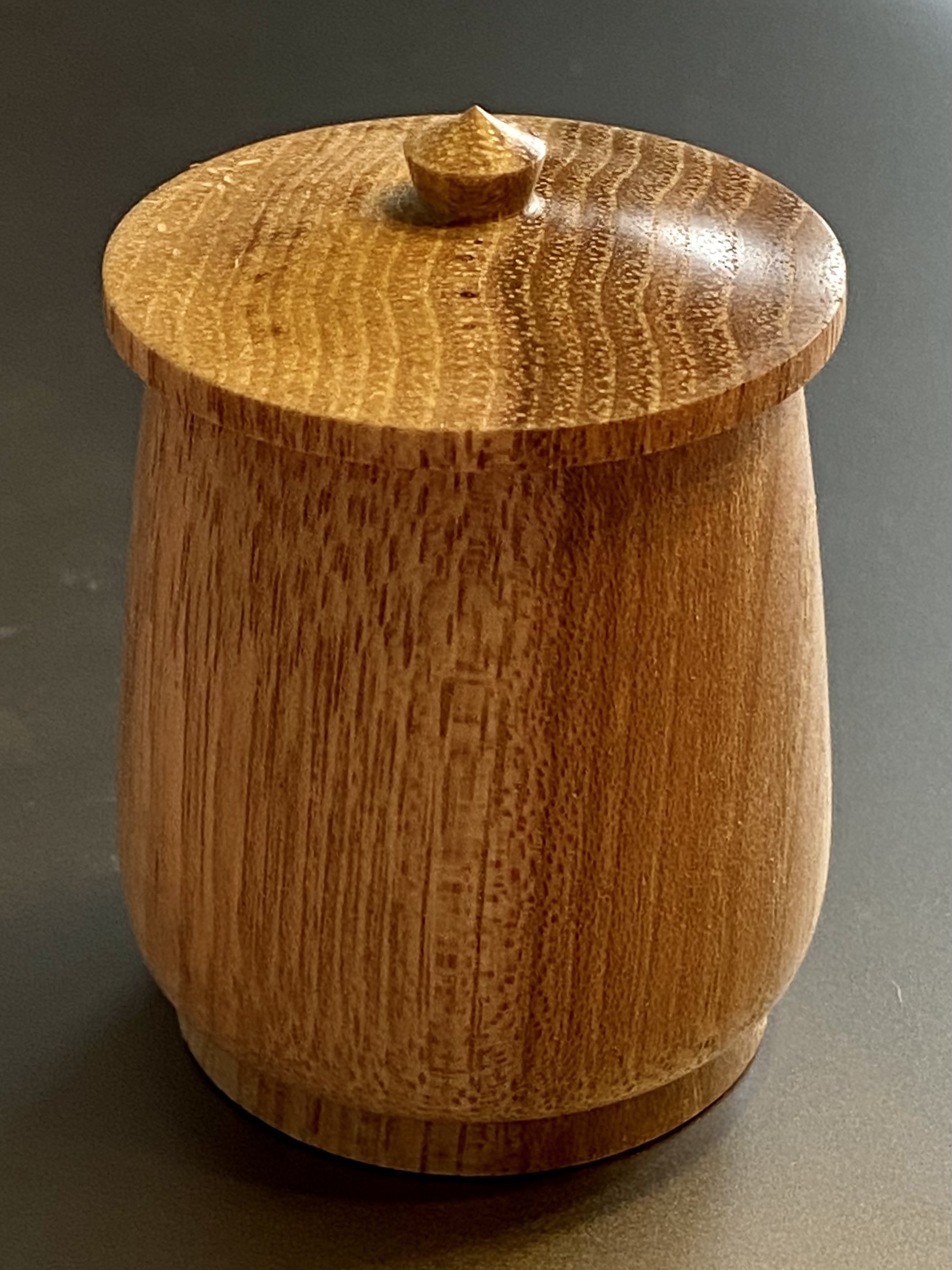Image of a pecan wood box with lid which has a tiny handle.