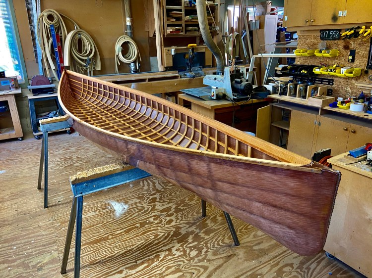 Image of a skin-on-frame canoe dyed brown.