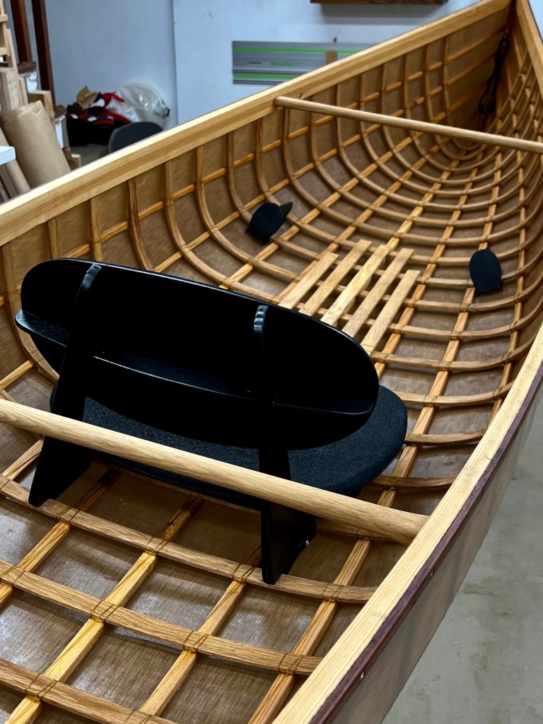 Image of solo skin-on-frame canoe.